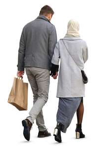 man and woman in a grey coats walking hand in hand