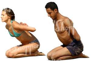 man and woman doing a yoga exercise on the beach