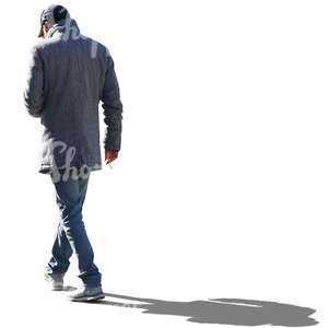 backlit man in a grey coat walking