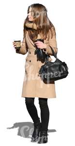 woman walking with a coffee cup in her hand