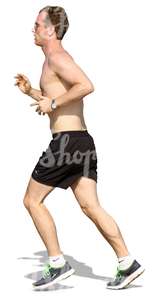 man in shorts jogging on the beach
