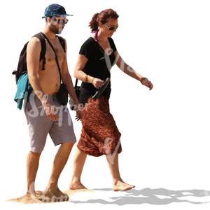 couple walking barefoot on a sandy beach