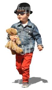 boy walking with a teddy bear under his arm