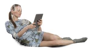 woman lying on the couch and looking at her ipad