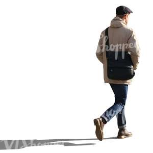 backlit man walking hands in his pocket