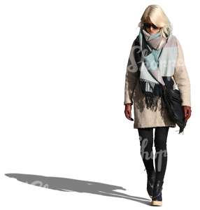 woman wearing a large scarf and coat walking