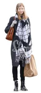 woman with a big scarf and a shopping bag standing