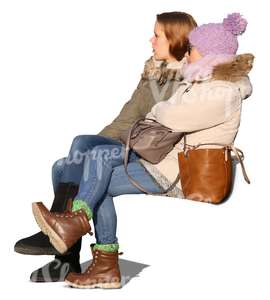 two teenage girls sitting in the autumn sun