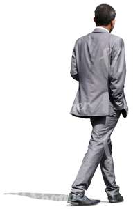businessman in a grey suit walking