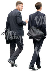 two businessmen in suits walking and talking