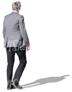 man in a grey jacket walking