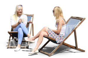 two women sitting on sling chairs and drinking coffee