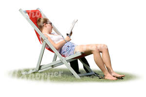 woman sitting in a sling chair and reading a magazine.