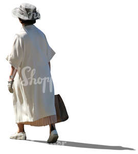 elderly lady in a white summer coat walking