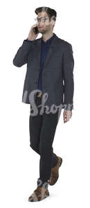 modern businessman walking and talking on the phone 