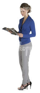 female office worker standing and looking at a magazine