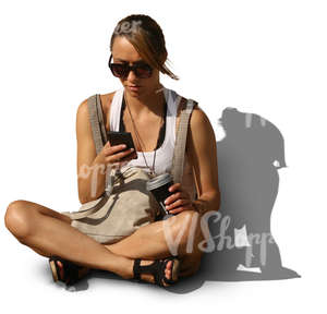 woman sitting on the ground and looking at her smartphone