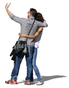 asian couple taking a selfie while hugging each other