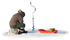 man ice fishing on a snowy lake