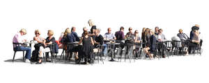 large group of people sitting in a street cafe