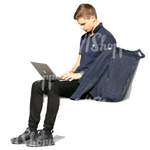 young man sitting on a bench and working on his laptop