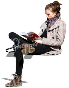 young woman sitting on a bench and reading