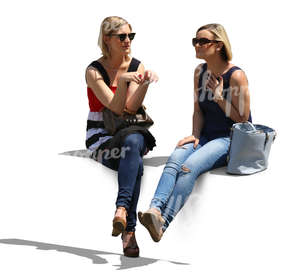 two women sitting and talking