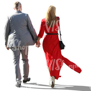 backlit couple in formal outfits walking hand in hand