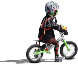 child wearing a helmet riding a likeabike