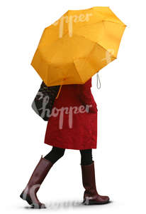 woman with a yellow umbrella walking in the rain