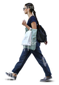 stylish woman with shopping bags walking in ambient light