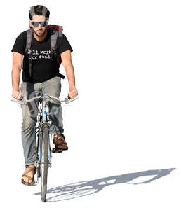 young man riding a bike in summertime