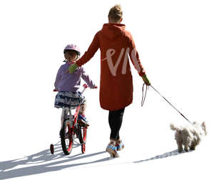 mother walking with her daughter who is riding a bike