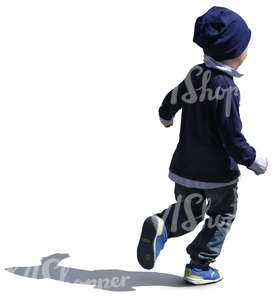 backlit small boy with a blue hat running