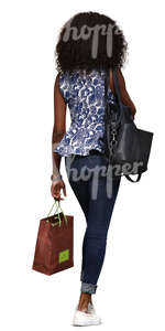 black woman with shopping bags walking down the street