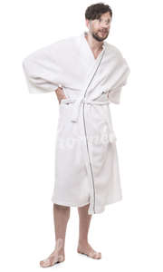 man in a white bathrobe standing in a spa