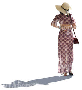backlit asian woman in a summer dress walking
