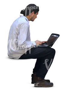 man sitting and working on his laptop