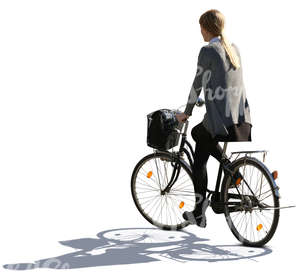 backlit woman riding a bike