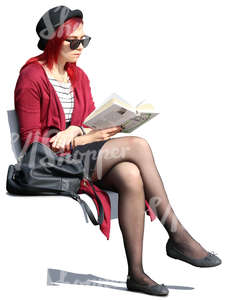 woman with sunglasses sitting outside and reading