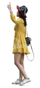 asian woman in a yellow summer dress standing