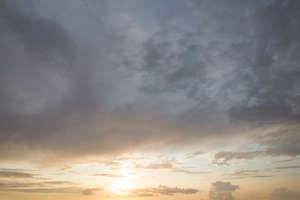 sunset sky with clouds and low sun