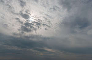 grey sky with sun visible behind the clouds