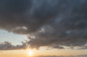 sunset with sun and dark clouds