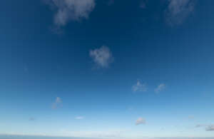 deep blue sky with few dots of clouds