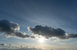 sky with sun and backlit clouds