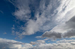 daytime sky with large white clouds