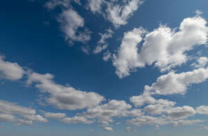 deep blue sky with small white clouds