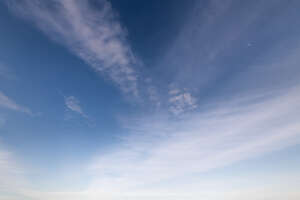 blue sky with few thin clouds