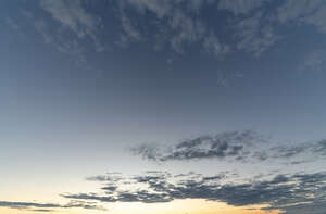 evening sky with yellow light and few clouds